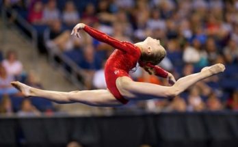 A Little Girl Gymnast make a move in the air