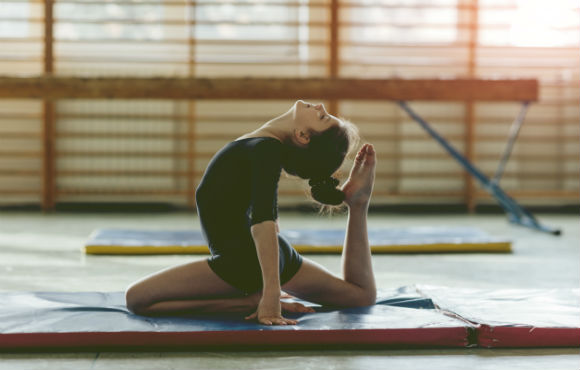 A young girl doing yoga in her practice session