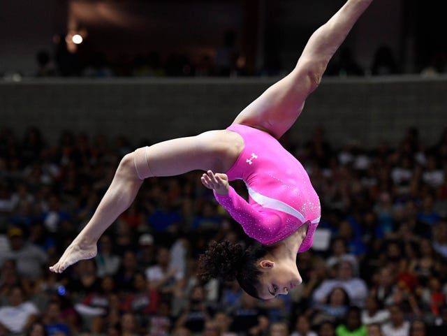 A girl gymnast doing reciprocal dive in the air