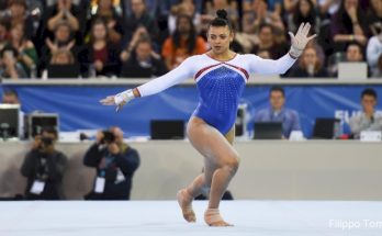 A Girl Athelete Gymnast In an action in a tournament