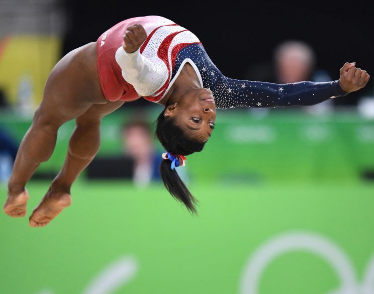 A girl gymnast doing reciprocal dive in the air